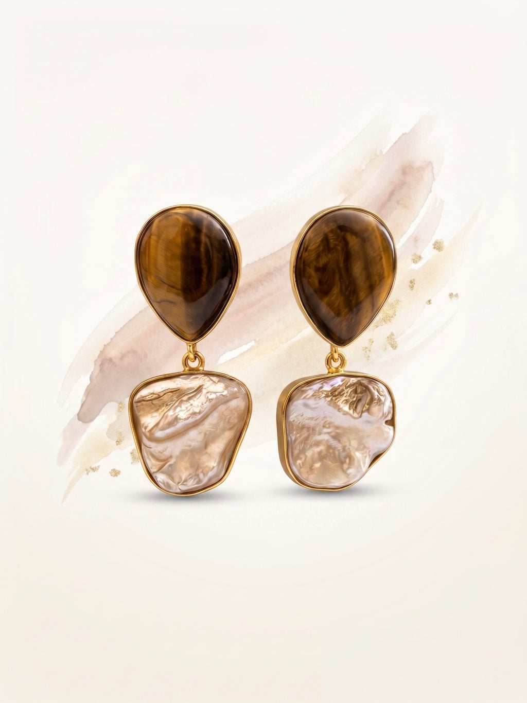 Pair of earrings with brown and beige stones on a light background